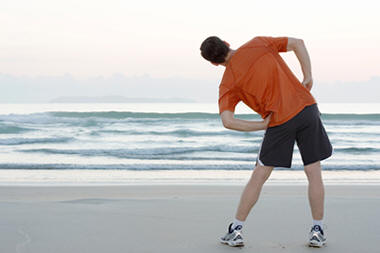 man on beach exercising