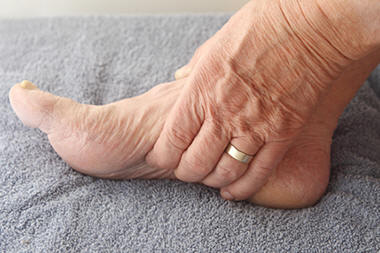 hand rubbing sore foot